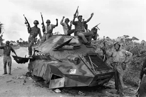 African Prints: Joyous Biafran soldiers seen here cheering with guns in the air as they sit atop a