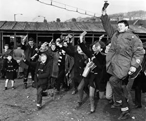 Jubilant Crystal Palace fans proudly hold aloft their tickets after having queued since