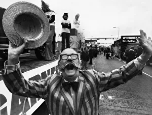 Floral Prints: Jubilant Ray Tonken throws up a jubilant cheer as his Tom garner float moves off in