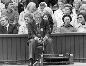 A judge watches the new electronic line equipment as Bjorn Borg of Sweden serves during