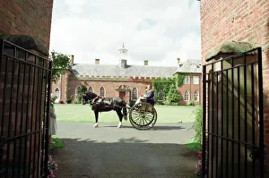 Judges in horse-drawn carriages view the village of Hartlebury, Worcestershire