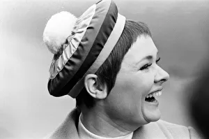 Judi Dench being photographed by the press wearing a Christian Dior beret called