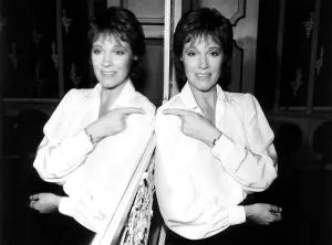 Julie Andrews Actress and Singer at London Airport LAP pointing at her reflection in