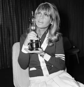 01164 Prints: Julie Christie and boyfriend Don Bessant arriving at London Airport after she was awarded