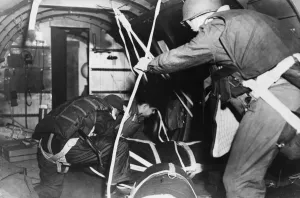 Airborne Prints: The jump master and crew chief push out supplies in para-packs from a transport plane for