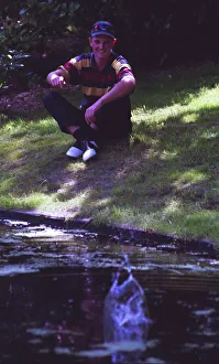 Justin Rose relaxes by throwing a stone in to the water at Hilversum in Holland during