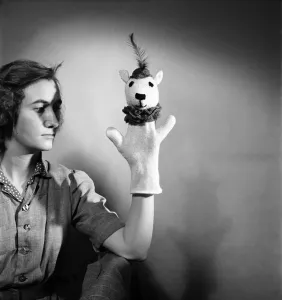 Puppets Prints: K. 41-Knitting woman modelling knitted hand puppet. February 1952 C6278