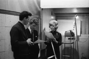 Karen Kay singer and actress in the recording studio discussing musical score with two