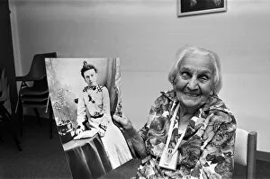 00930 Collection: Kate Willison celebrates her 100th birthday. She is holding a picture of herself in her