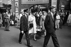 Katharine, Duchess of Kent, carrying her baby in a carry cot with the aid of the nurse