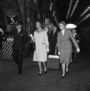 01169 Prints: Katharine, Duchess of Kent, carrying her baby in a carry cot with the aid of the nurse