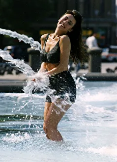 Kathy Lloyd launches Empires Winter Collection standing in a fountain smiling