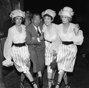 Kay Kendall left, enjoying a dance with ( left to right) Noel Coward