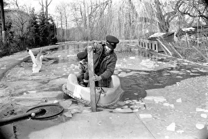Keepers at Chessington Zoo chip the ice on the storks and ducks pond
