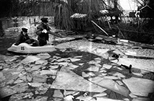 Keepers at Chessington Zoo chip the ice on the storks and ducks pond