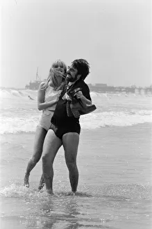 Keith Moon, drummer of The Who rock group with model Annette Lax in the resort of Malibu