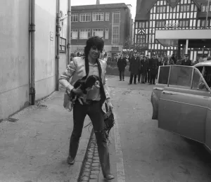 Keith richards arrives at Coventry Theatre carrying a young King Charles Spaniel under
