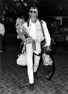 Kelly Emberg wife of Rod Stewart with daughter Ruby at Heathrow leaving for Los Angeles