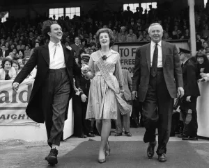 Ken Dodd and Mr. Harold Wilson walk towards the platform at Belle Vue Stadium with the 15