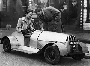 Motoring Prints: Kenneth See of Oxford Road, Reading, shows his wide Georgina the controls of his electric