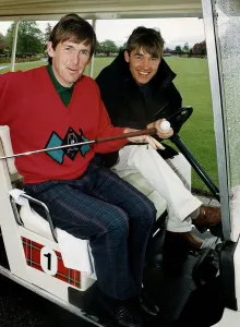 Kenny Dalglish and Stephen Hendry at golf course in golf cart holding club