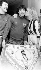 Kiss Prints: Kevin Keegan gets his birthday kiss from Julie Parkinson watched by team mate Terry