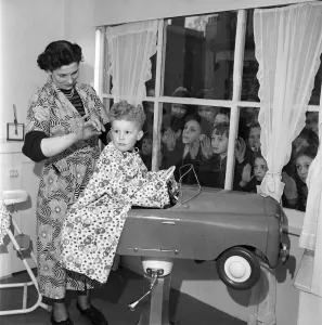 Kiddies pressing their noses against the window as they watch Christopher Chaplin aged 4
