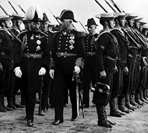 Standing To Attention Prints: King George V seen here inspecting a naval guard of honour during a visit to Aberystwyth