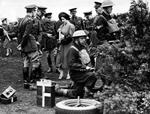 King Geroge V1 April 1939 looking at the Queen examining an anti land shell