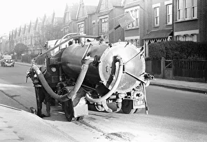 Tanker Prints: A Kingston Upon Thames council worker seen here cleansing the gullys and sewers