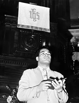 Idsarchivesmw Prints: Kitione Lave 21 years old Tongan Heavy weight boxer reading the lesson at a methodist