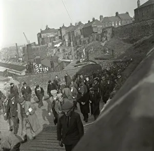 Flat Caps Prints: Knocking off of work are the shipyard workers of P. S. Austin shipyards on the river Wear