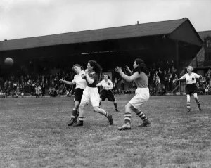 Ladies Association Football. England v. Scotland. A Scottish defender makes a vigorous