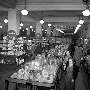 00169 Prints: Ladies look at crockery and glasses for sale during the January sales in Kensington High