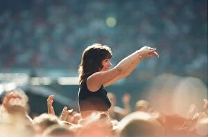 Images Dated 23rd July 1995: A lady aloft and enjoying the day, part of the huge audience watch American Rock Group