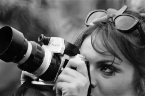 Folk Prints: A lady festival goer takes a picture with her Nikon Camera at The Windsor Jazz Festival