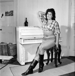 Large chested Denise Crooke seen here banging out a tune on the piano. 1965