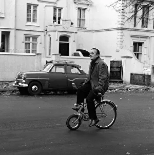 Larry Adler world famous Harmonica player on his way to a concert at Camden Town on a