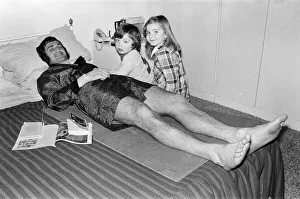 00244 Prints: Larry Lloyd Coventry City football player lying on bed at home as he recuperates