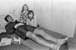 Larry Lloyd Coventry City football player lying on bed at home as he recuperates
