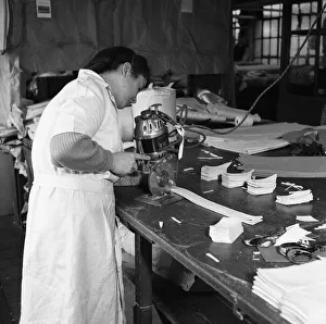Latex being cut for straps for corsets and girdles at the Spirella Corset factory in