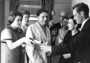 Laurence Olivier and wife Joan Plowright meeting Charlton Heston backstage after