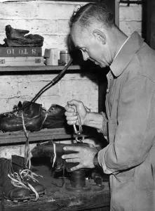 00254 Prints: Laurie Barnett is seen attending to Ivor Broadis football boots