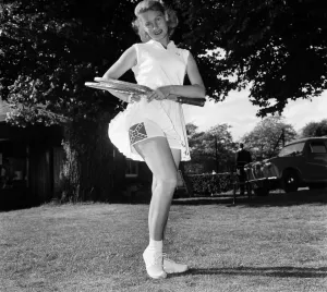 00039 Prints: Lawn Tennis at Beckenham. Woman holding a tennis racket wearing a sports dress