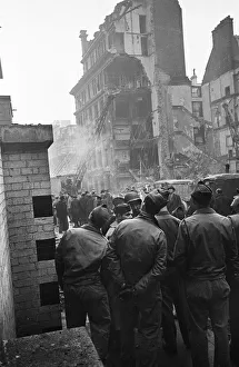 LCC and Civil Defence workers seen here clearing up following a V2 explosion at the Red
