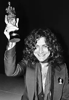 Lead singer of group Led Zeppelin Robert Plant with an Ivor Novello Award
