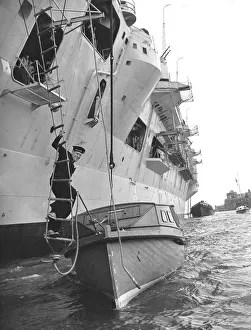 00133 Prints: Leading Seaman Philip Benjamin climbs down a rope ladder from HMS Eagle to an awaiting