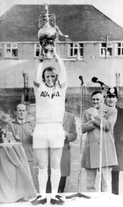 Leeds United captain Billy Bremner holds up The League Cup with manager Don Revie