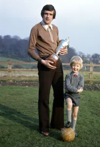 Leeds United footballer Norman Hunter with his five year old son Michael holding