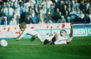 Leeds United footballer Vinnie Jones tackling the match mascot. 23rd October 1989